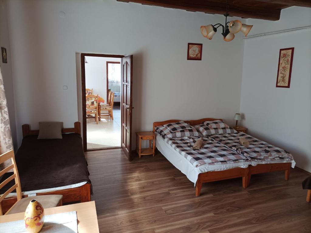 a bedroom with a bed and a table and a mirror at Kemencés Vendégház in Mikóháza