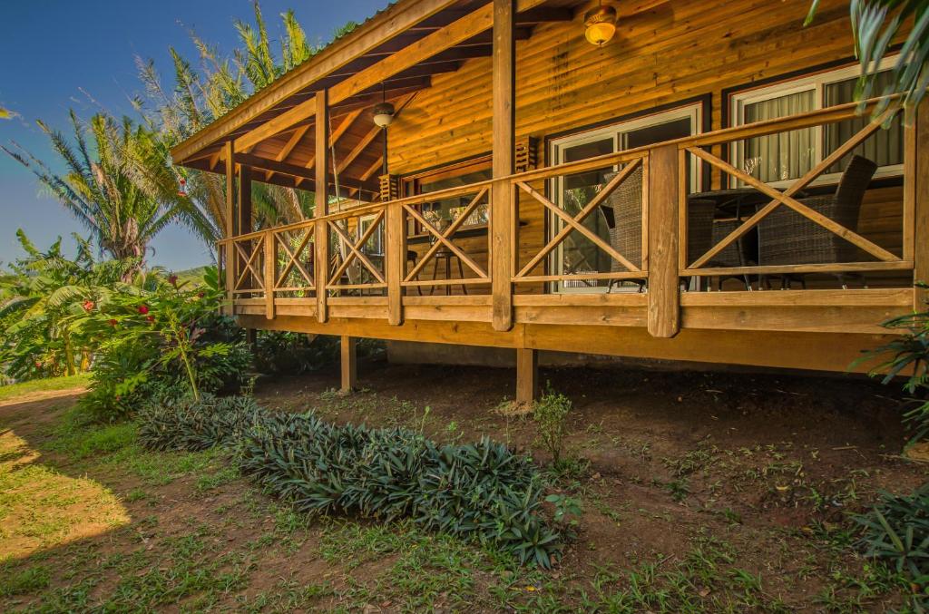 a wooden house with a porch on the side of it at Relaxing Tropical Cabin in Roatan