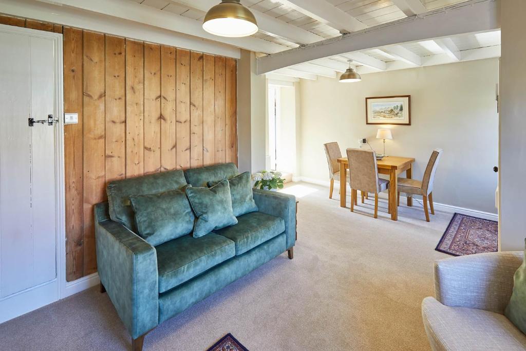 a living room with a couch and a table at Host & Stay - Holmlea Cottage in Lockton