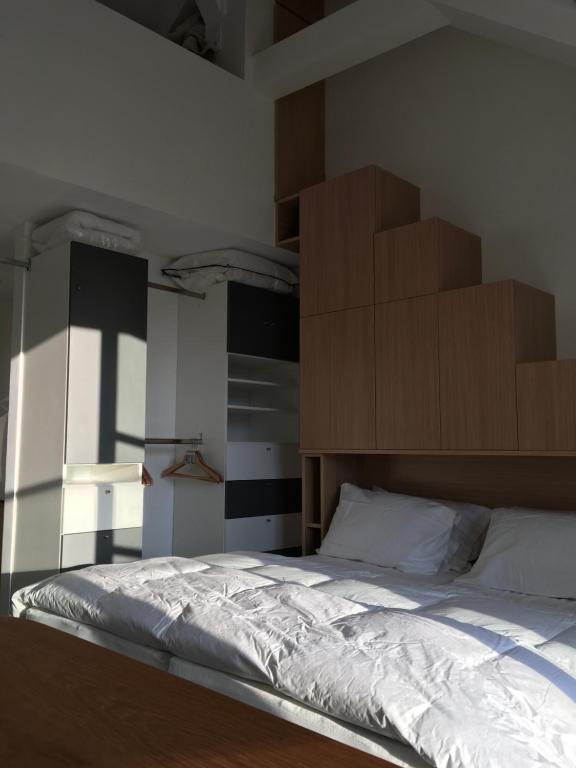 a bedroom with a bed with boxes on the wall at Logement Climatisé Erdre Rivière in La Chapelle-sur-Erdre