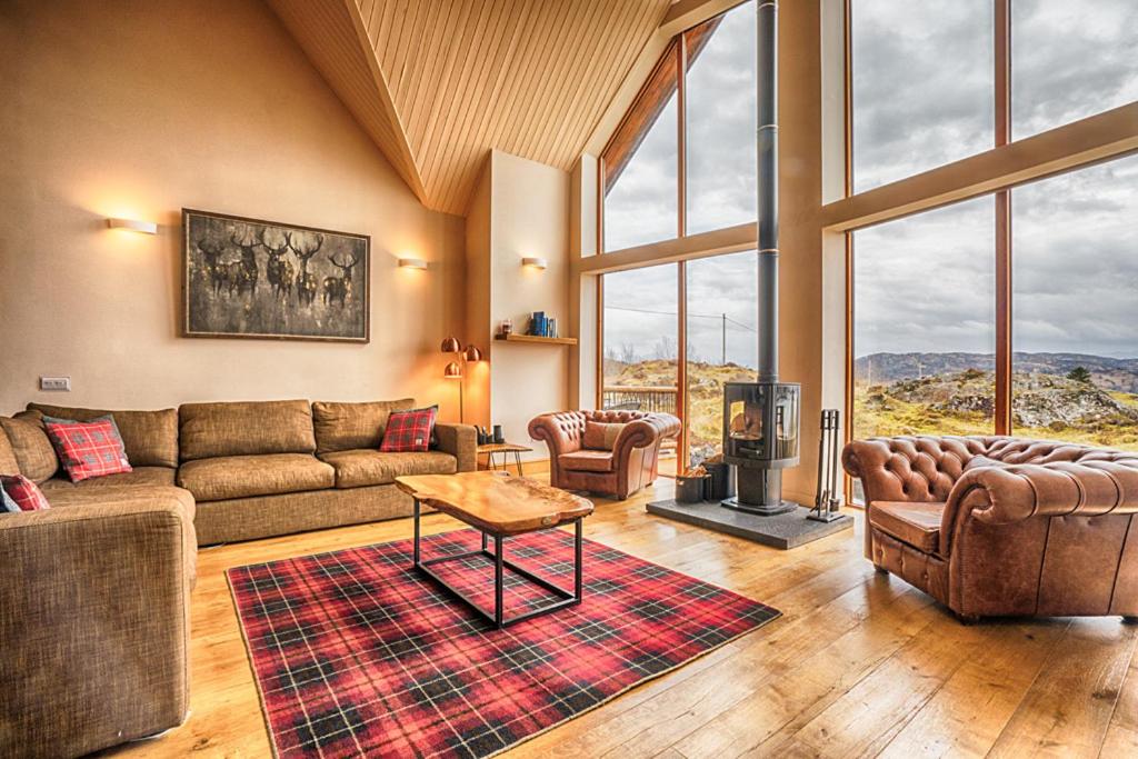 a living room with a couch and a table at Waterloo House in Lochinver