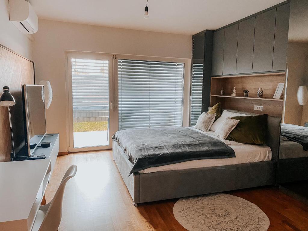 a bedroom with a large bed and a television at Oasis of Energy in Ljubljana