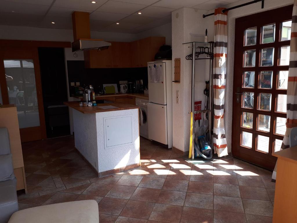 a kitchen with a refrigerator and a counter top at Haus Rosi Einliegerwohnung in Weiskirchen