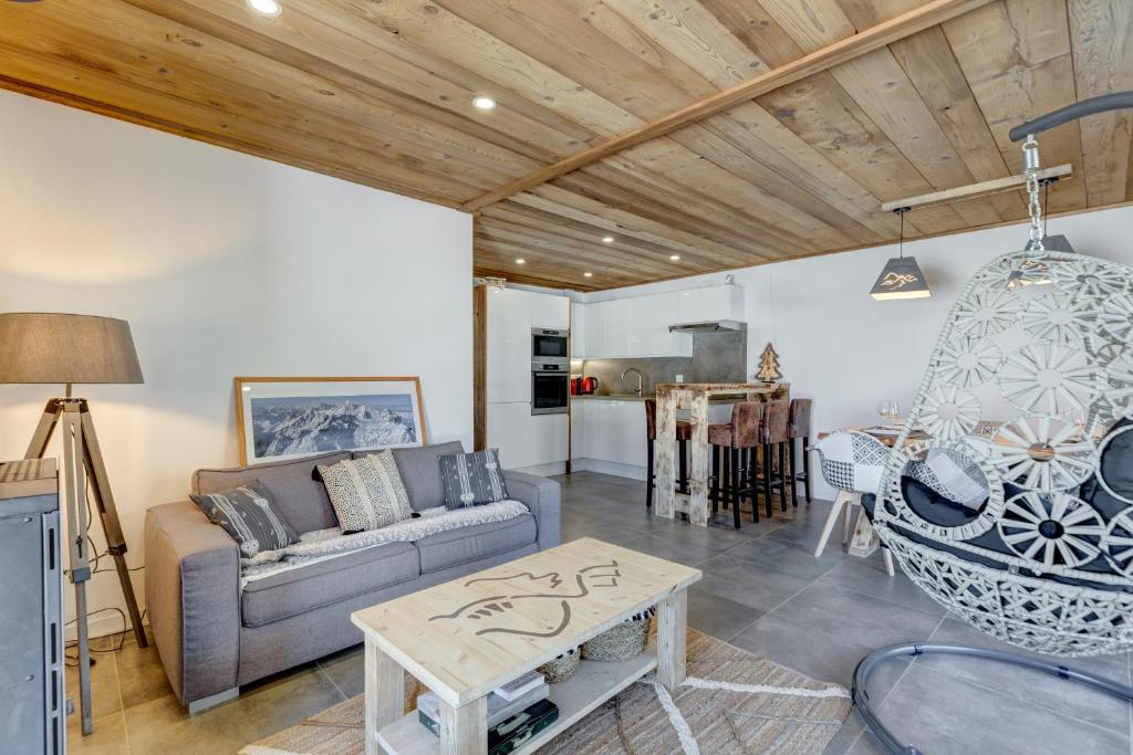 a living room with a couch and a table at Les Nards in Praz-sur-Arly