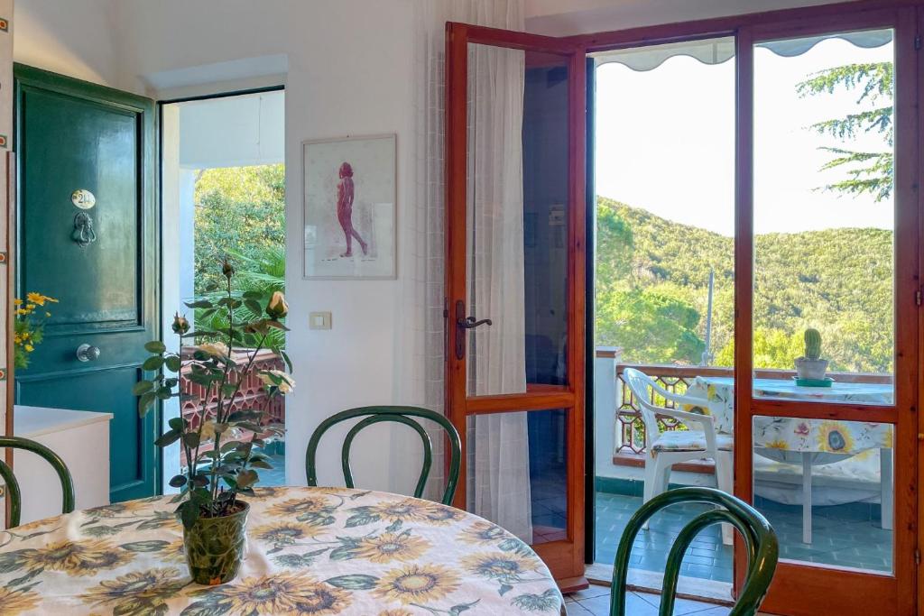 a dining room with a table and chairs and a window at Appartamento La Vacanza in Rio nellʼElba