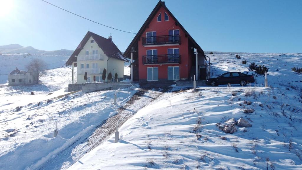 a red and white house in the snow at Villa Ela in Kupres