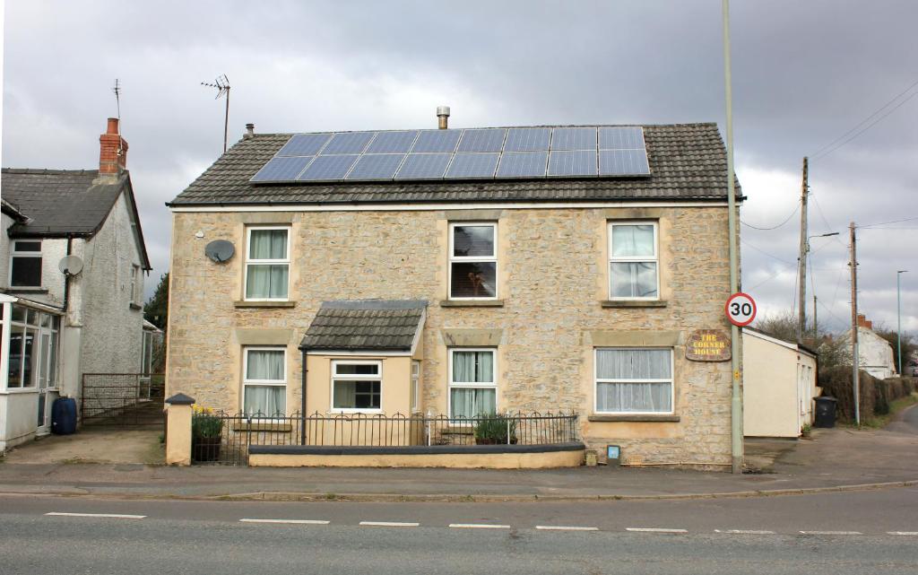 a house with solar panels on top of it at The Corner House - Historic Character Cottage in the Forest in Coleford