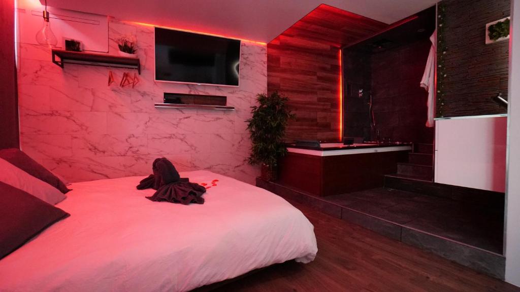 a bedroom with a white bed and a red lighting at Suite morning star in La Seyne-sur-Mer