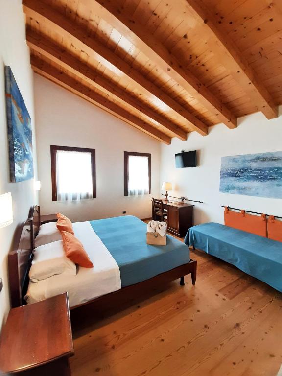Postel nebo postele na pokoji v ubytování Agriturismo Le Cipressine