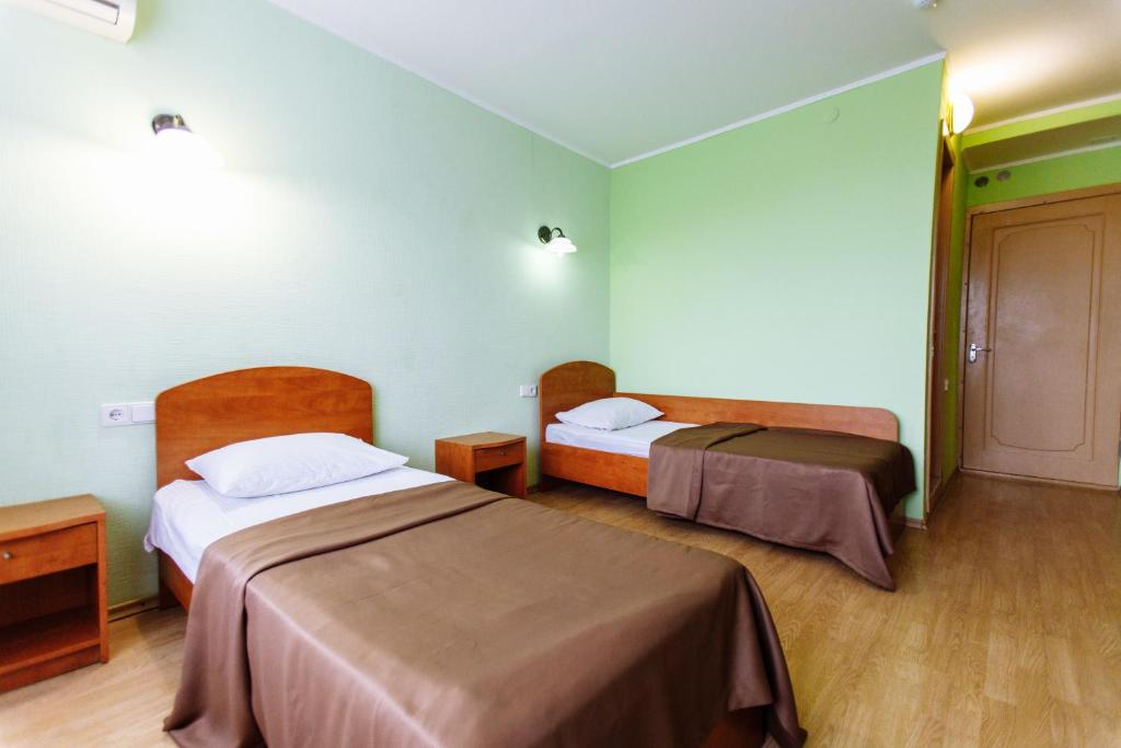 a hotel room with two beds in a room at Tavria Hotel in Simferopol