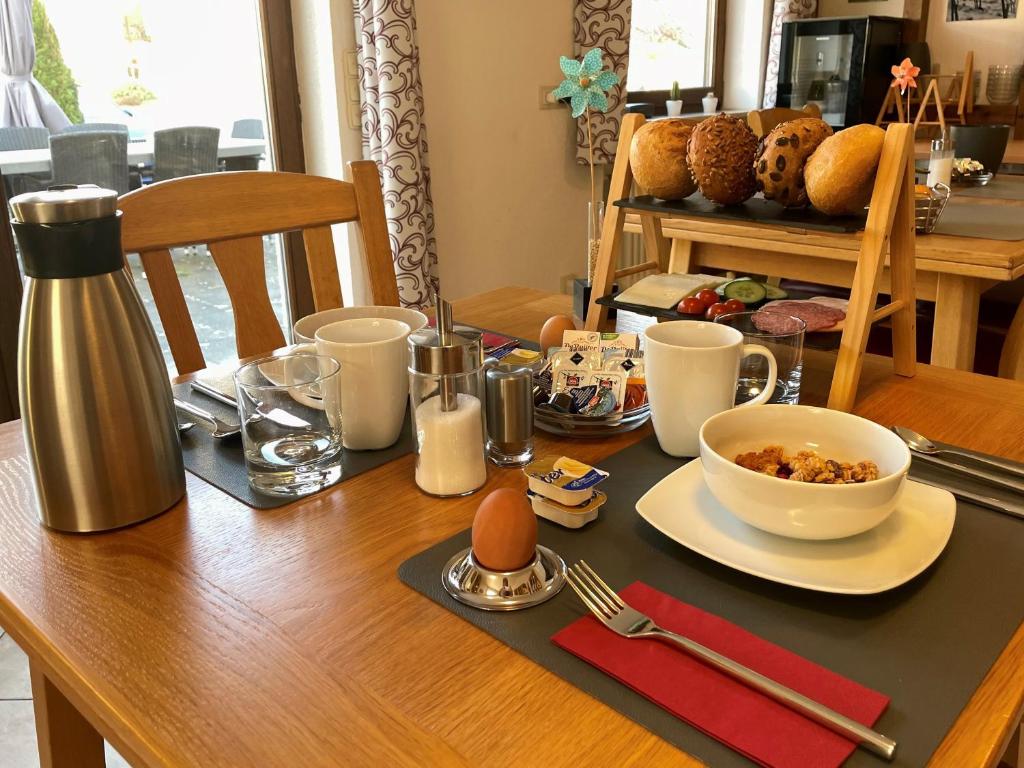 a table with an egg and a bowl of food on it at Weingut H. Gindorf in Lieser