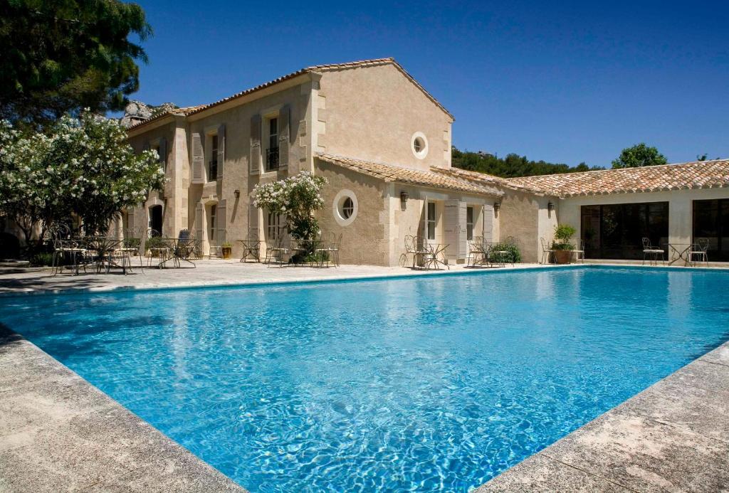 a large swimming pool in front of a house at Benvengudo in Les Baux-de-Provence