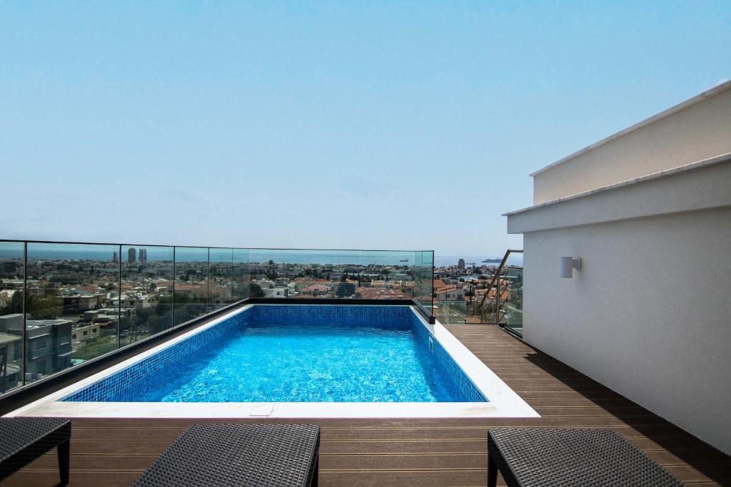 a swimming pool on the balcony of a building at Phaedrus Living: Sea View Anna Residence 301 in Limassol