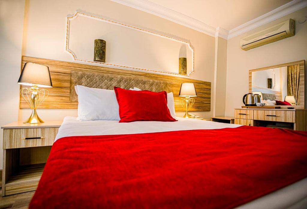 A bed or beds in a room at Gülec Konak Hotel