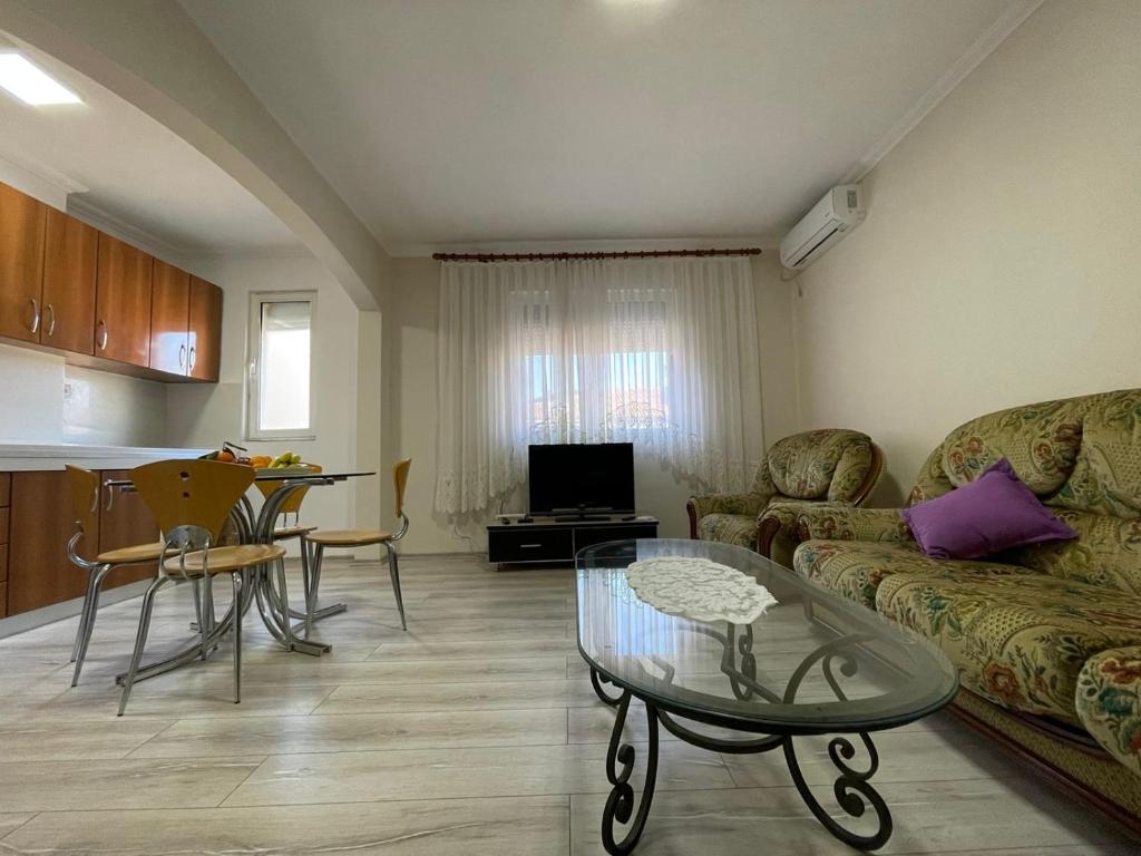 een woonkamer met een bank en een tafel bij Prestige Rentals in Shkodër