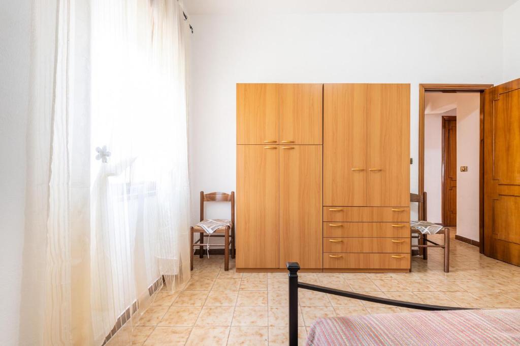 Posteľ alebo postele v izbe v ubytovaní Casa Vacanze Teulada