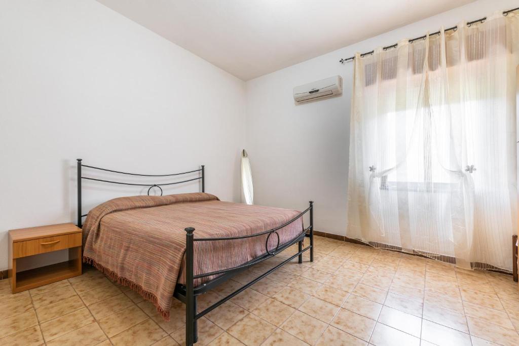 Posteľ alebo postele v izbe v ubytovaní Casa Vacanze Teulada