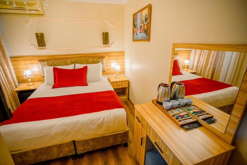 A bed or beds in a room at Gülec Konak Hotel