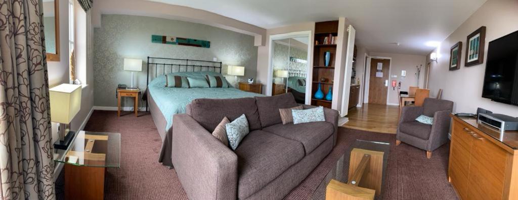 a living room with a couch and a bed at Fell View in Troutbeck