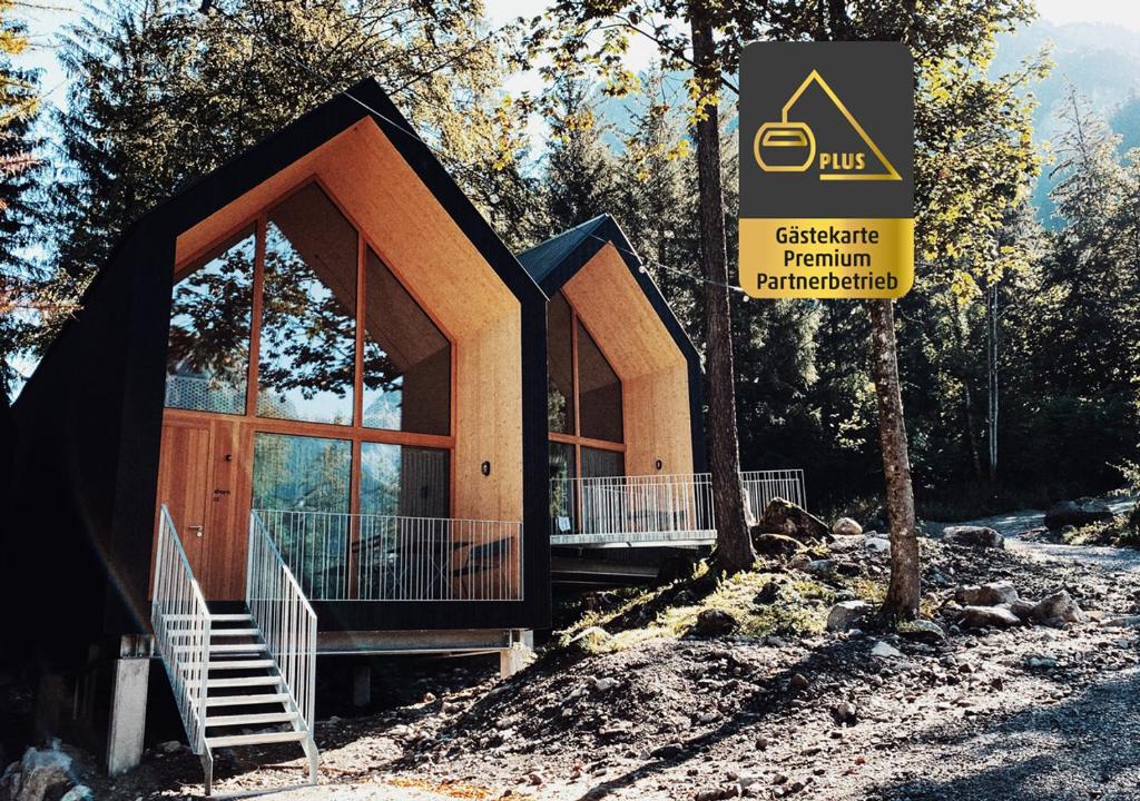 a building with a sign in front of it at Älmele - Waldchalets Brandnertal in Brand