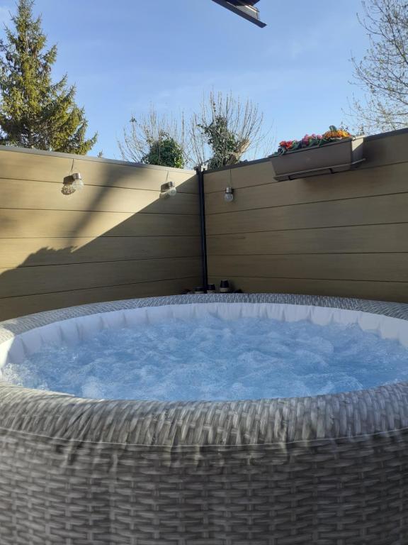 a large hot tub in front of a fence at Gite La vallée du silence in Le Beausset