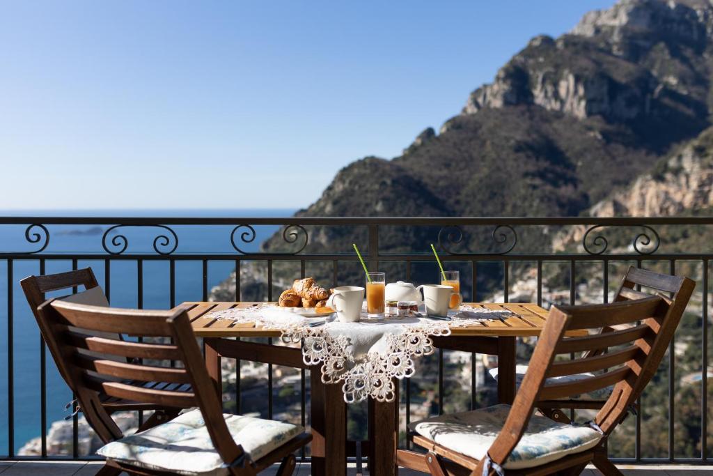 a table with food on top of a balcony at Casa la Perla in Positano