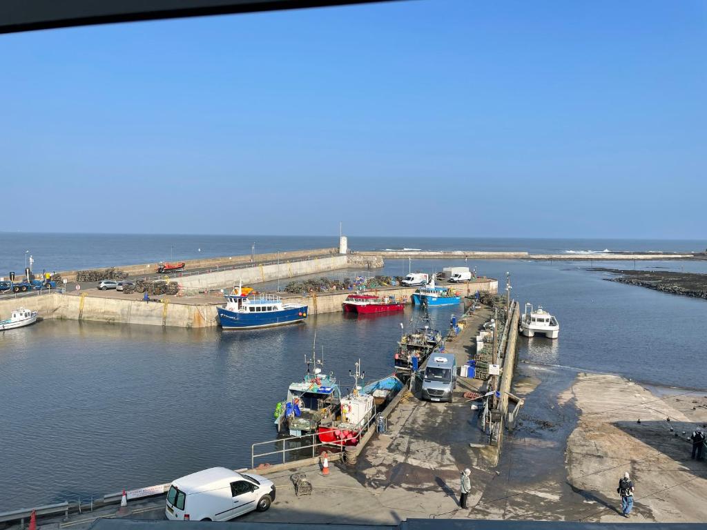 a group of boats are docked in a harbor at Chandlers BnB in Seahouses