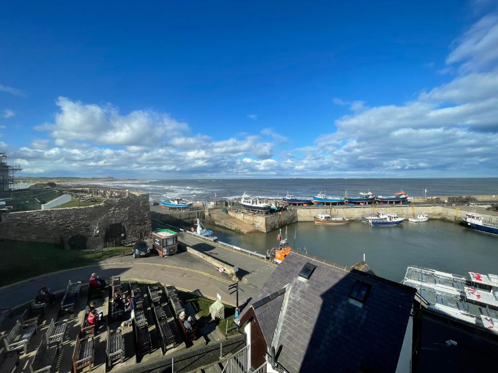 a view of a harbor with boats in the water at Chandlers BnB in Seahouses