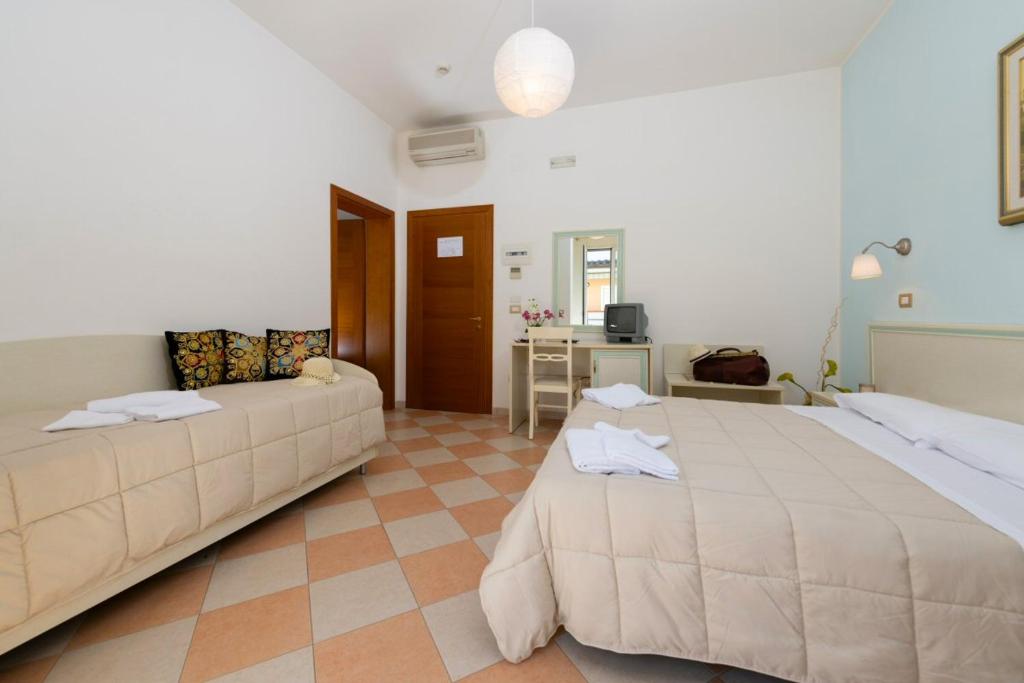 Postel nebo postele na pokoji v ubytování Hotel Bruna