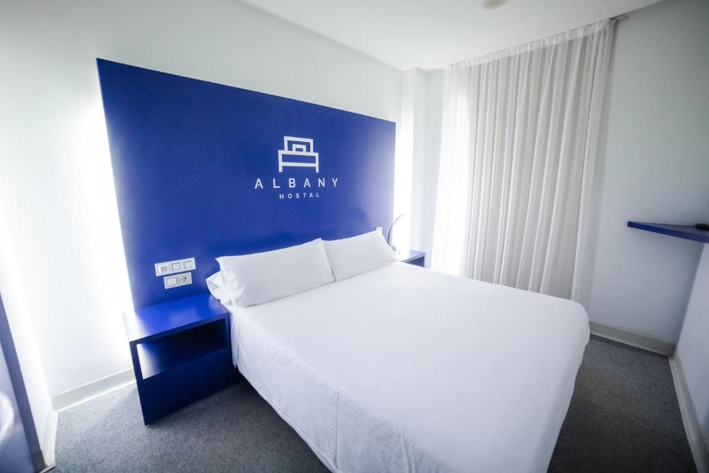 Posteľ alebo postele v izbe v ubytovaní Hostal Albany