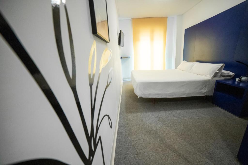 Posteľ alebo postele v izbe v ubytovaní Hostal Albany