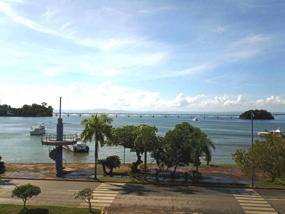 a view of a river with boats and a bridge at Indy's Best Bay FrontView in Samana. in Santa Bárbara de Samaná