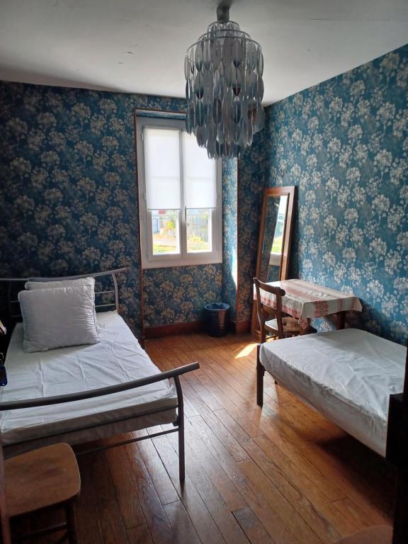 a bedroom with two beds and a chandelier at Gite Compostella in Saint-Jean-Pied-de-Port