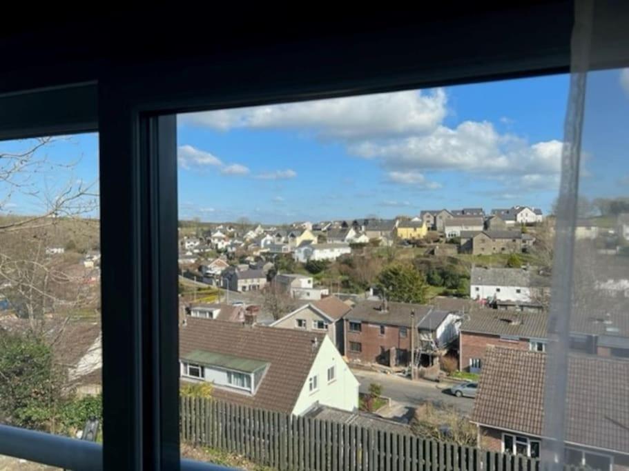 a view of a city from a window at Orchard Lodge -Coastal Retreat, new build, village views, private garden and terrace in Saint Brides Major