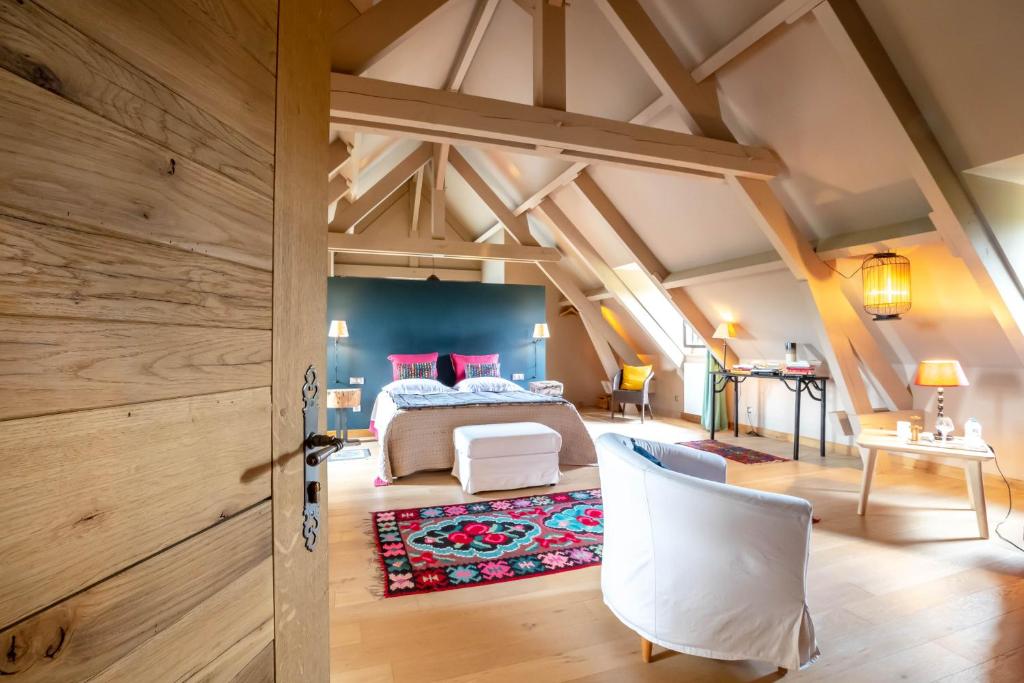 a bedroom with a king sized bed in a attic at Domaine des Closeaux in Puligny-Montrachet