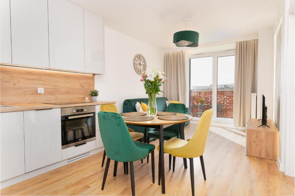 a kitchen and dining room with a table and chairs at South4You Apartments in Wrocław