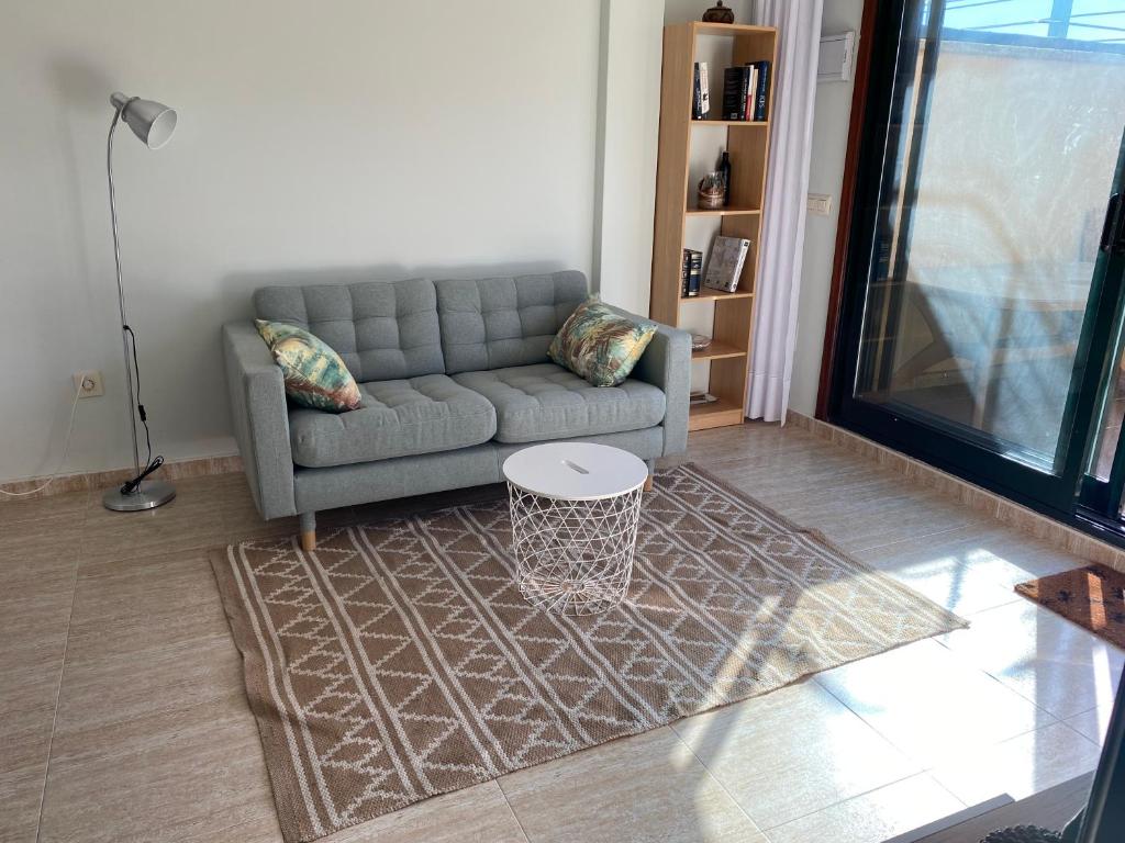 a living room with a couch and a table at San Vicente do Mar , playa in Pontevedra