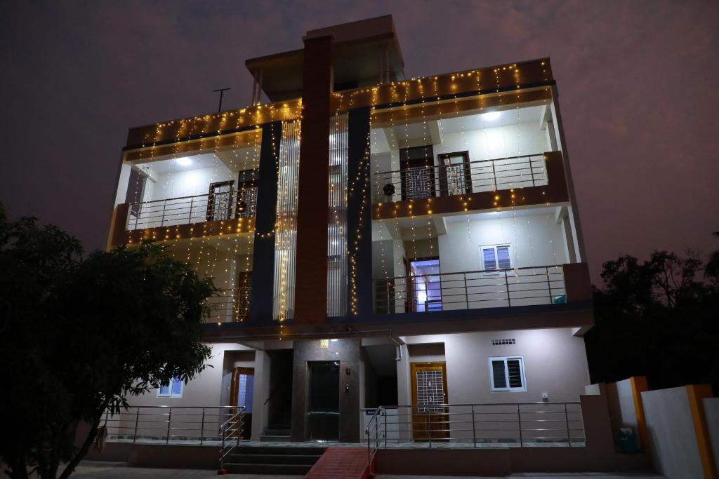 a building with lights on it at night at Two Bedroom Flat Non AC Varun Vihar Near Horsley Hills in Kurabalakota