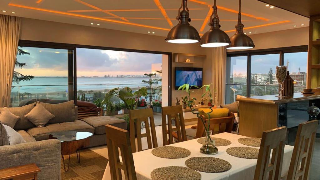 a dining room with a view of the ocean at PRESTIGIA ESSAOUIRA MOGADOR Luxury Ocean View in Essaouira