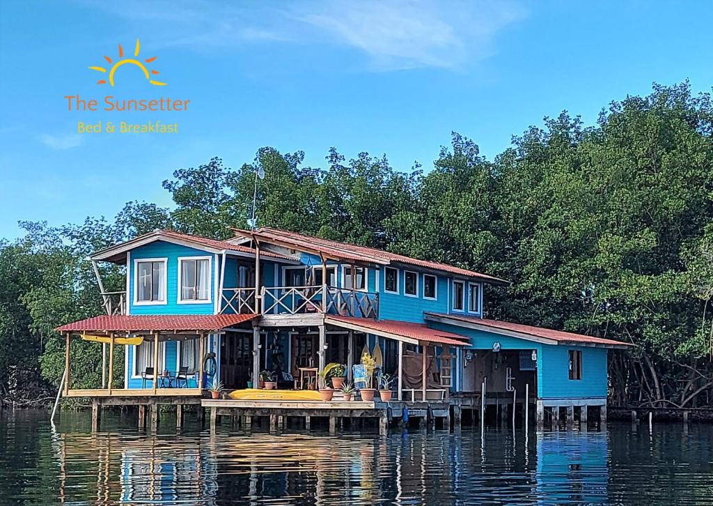 a house on a dock in the water at The Sunsetter Bed & Breakfast in Bocas del Toro