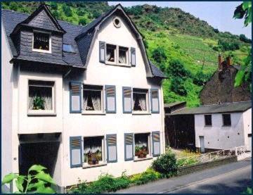 a large white house with windows on a hill at Gästehaus Aladin in Cochem