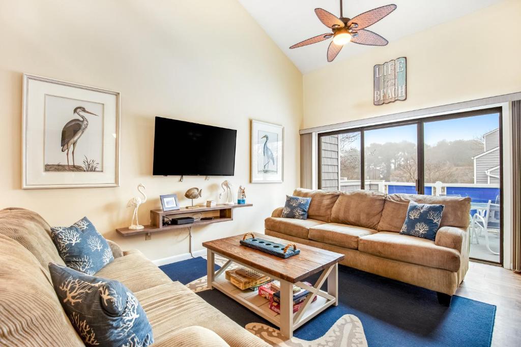 a living room with a couch and a tv at East of the Sun --- 39620 East Sun Drive #726 in Fenwick Island