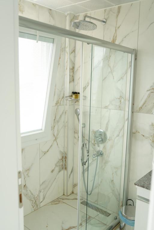 a shower with a glass door in a bathroom at Blue Island Luxury Hotel Adults Only in Kaş