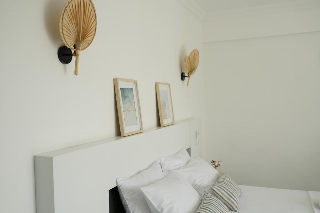 a white bedroom with a shelf and a bed at Blue Island Luxury Hotel Adults Only in Kaş