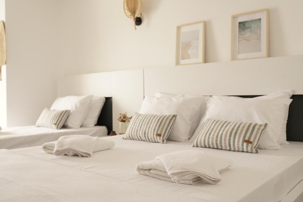 a white bed with two pillows on top of it at Blue Island Luxury Hotel Adults Only in Kaş