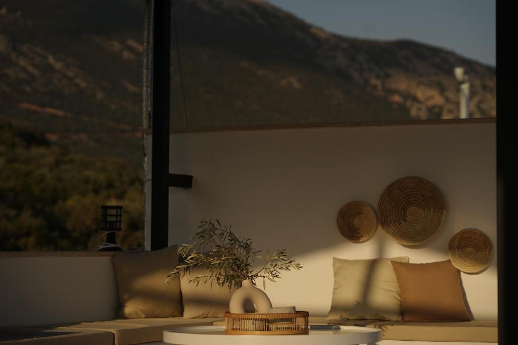 a living room with a couch and pillows on a wall at Blue Island Luxury Hotel Adults Only in Kaş