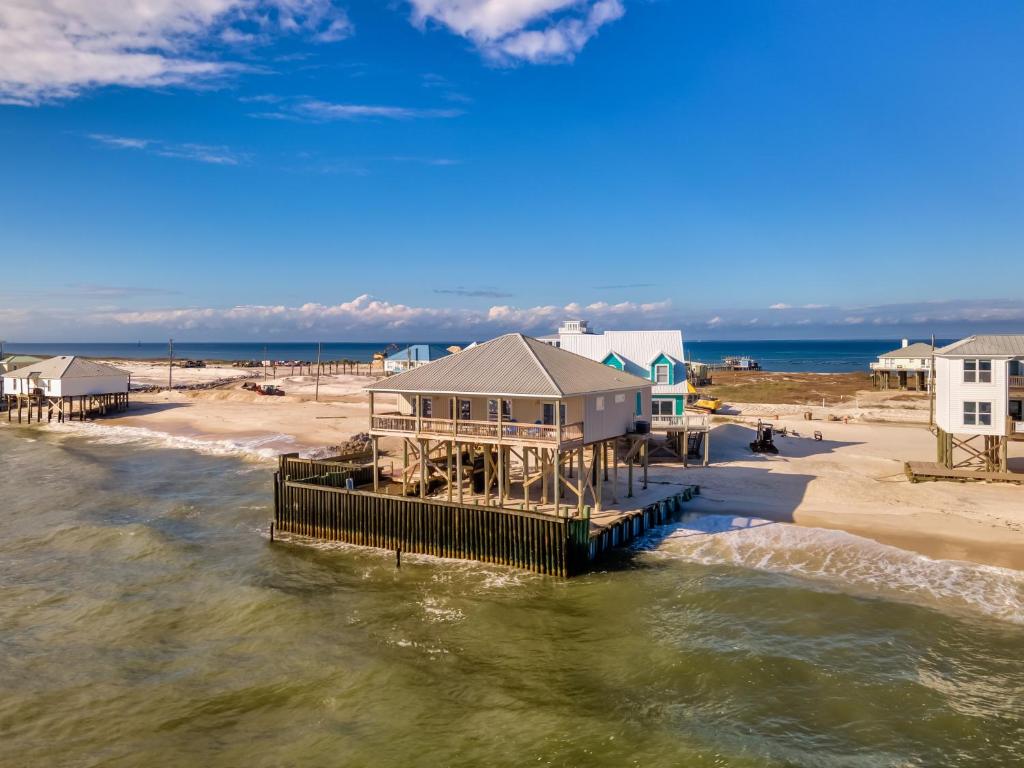 an aerial view of a beach with houses and the water at West Beach - Stay ON the sand! Gulf views galore, only steps to the shore! home in Dauphin Island