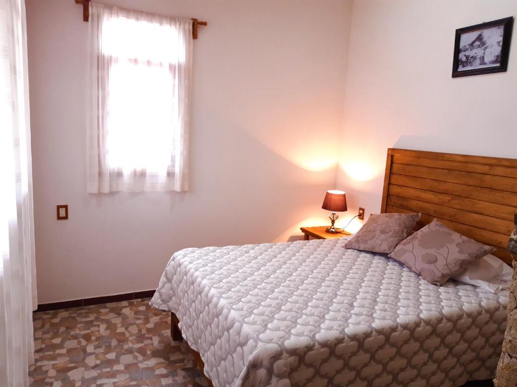 Postel nebo postele na pokoji v ubytování Cabañas Los Olivos