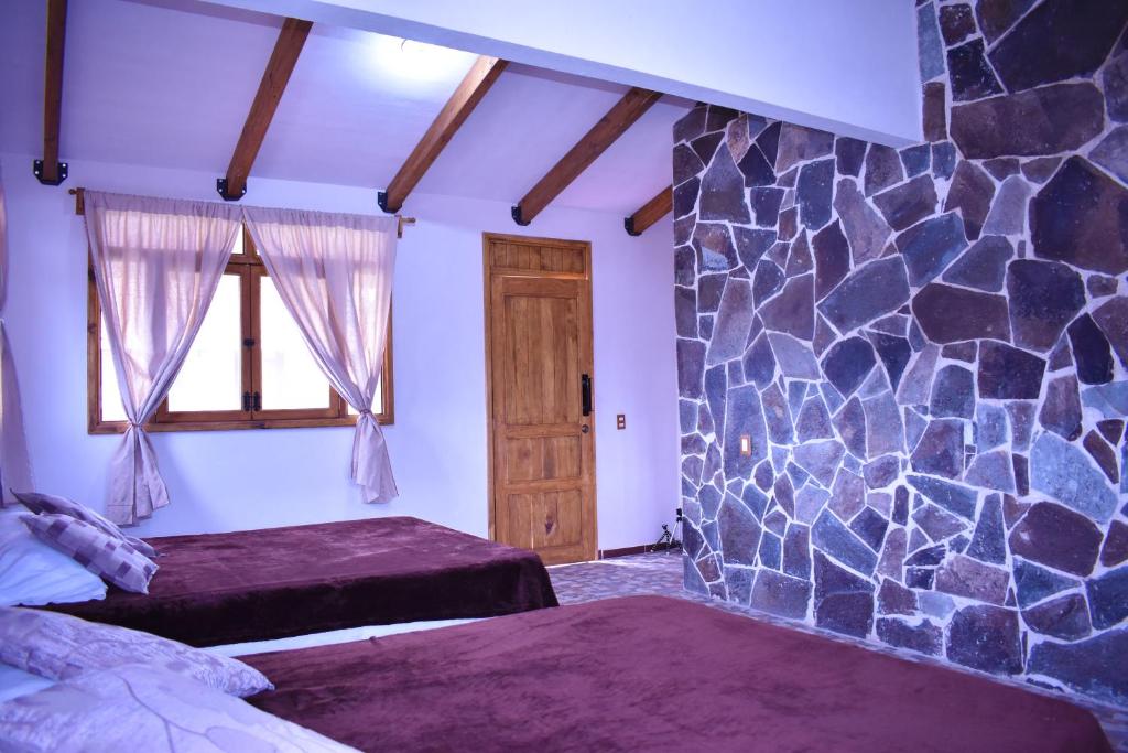 Postel nebo postele na pokoji v ubytování Cabañas Los Olivos