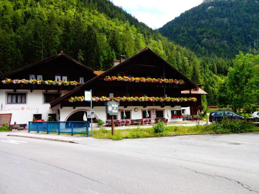 a building with flowers on the side of it at Gasthof zur Mühle in Leutasch